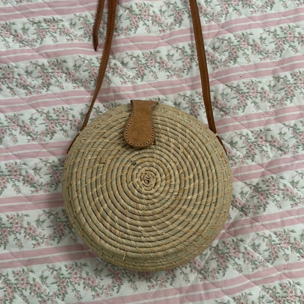 Circular woven straw purse with adjustable leather strap